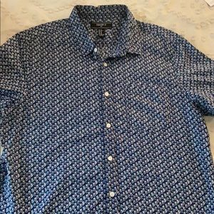 Blue button down shirt with white flower pattern